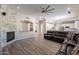 Spacious living room with a stone fireplace and kitchen view at 1912 E Gemini Pl, Chandler, AZ 85249