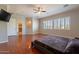 Main bedroom with hardwood floors, plantation shutters and ceiling fan at 1912 E Gemini Pl, Chandler, AZ 85249