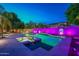 Night view of a vibrant pool with purple lighting at 1912 E Gemini Pl, Chandler, AZ 85249