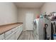 Laundry room with built-in cabinets and space for a washer and dryer at 1912 E Gemini Pl, Chandler, AZ 85249
