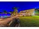 Night view of backyard oasis with pool and garden accents at 1912 E Gemini Pl, Chandler, AZ 85249