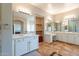 Elegant bathroom with double sinks, walk-in shower, and large mirror at 1912 E Gemini Pl, Chandler, AZ 85249