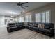 Comfortable living room featuring a sectional sofa and ceiling fan at 1912 E Gemini Pl, Chandler, AZ 85249