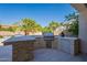 Modern outdoor kitchen with grill and stone countertops at 1912 E Gemini Pl, Chandler, AZ 85249