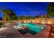 Inviting backyard oasis featuring a sparkling pool, spa, and outdoor lighting at 1912 E Gemini Pl, Chandler, AZ 85249