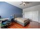 Spacious bedroom with wood floors, ceiling fan, and ample closet space at 1912 E Gemini Pl, Chandler, AZ 85249
