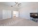 Large bedroom with ceiling fan, double door closet, and access to upper loft area at 1912 E Gemini Pl, Chandler, AZ 85249
