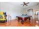 Game room features a pool table, arcade game, and hardwood floors at 1912 E Gemini Pl, Chandler, AZ 85249