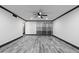 Spacious living room featuring grey vinyl plank flooring and a ceiling fan at 4505 W Mclellan Rd, Glendale, AZ 85301