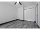 Bedroom with ceiling fan, gray vinyl flooring, and double door closet at 4505 W Mclellan Rd, Glendale, AZ 85301