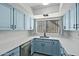 Updated kitchen with light blue cabinets and stainless steel appliances at 4505 W Mclellan Rd, Glendale, AZ 85301