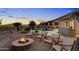 Inviting backyard oasis featuring a sparkling pool, fire pit, and ample seating at 34599 N 99Th Way, Scottsdale, AZ 85262