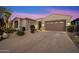 Single-story home with desert landscaping and two-car garage at 34599 N 99Th Way, Scottsdale, AZ 85262