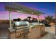 High-end stainless steel grill and outdoor kitchen with pergola at 34599 N 99Th Way, Scottsdale, AZ 85262