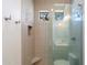 Large shower with glass enclosure, bench seat and natural light at 34599 N 99Th Way, Scottsdale, AZ 85262
