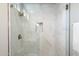 Modern shower with marble tile and glass enclosure at 34599 N 99Th Way, Scottsdale, AZ 85262