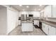 Updated kitchen with white cabinets, island, and stainless steel appliances at 6742 N 43Rd Ave, Glendale, AZ 85301