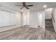 Spacious living room with wood-look floors and stairs at 6742 N 43Rd Ave, Glendale, AZ 85301