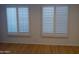 Bright bedroom with hardwood floors and plantation shutters at 3114 E Hazelwood St, Phoenix, AZ 85016