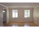 Spacious living room with hardwood floors and large windows at 3114 E Hazelwood St, Phoenix, AZ 85016