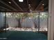 View of a covered patio with a ceiling fan and lush greenery at 3114 E Hazelwood St, Phoenix, AZ 85016