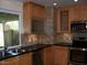 Updated kitchen featuring wood cabinets, granite countertops, and stainless steel appliances at 3114 E Hazelwood St, Phoenix, AZ 85016