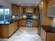 Modern kitchen with light wood cabinets, stainless steel appliances, and tile flooring at 3114 E Hazelwood St, Phoenix, AZ 85016
