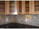 Close-up view of kitchen backsplash with tan and beige mosaic tiles at 3114 E Hazelwood St, Phoenix, AZ 85016