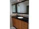 Bathroom with black granite countertop, double sinks, and stone accents at 3114 E Hazelwood St, Phoenix, AZ 85016