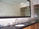 Bathroom with black granite countertop, double sinks, and stone accents at 3114 E Hazelwood St, Phoenix, AZ 85016