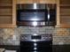 Stainless steel microwave and stovetop in a modern kitchen setting at 3114 E Hazelwood St, Phoenix, AZ 85016