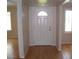 Light and bright entryway with hardwood floors and a classic white door at 3114 E Hazelwood St, Phoenix, AZ 85016