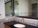 Bathroom with black granite countertop, double sinks, and stone accents at 3114 E Hazelwood St, Phoenix, AZ 85016
