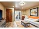 Comfortable sitting area with a wooden door, french doors, and a plush sofa at 8599 E Tecolote Cir, Scottsdale, AZ 85266