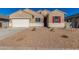 Tan two-story house with white garage door and red shutters at 7010 E Drygulch Rd, San Tan Valley, AZ 85143