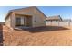 House backyard with a patio and grassy area at 7010 E Drygulch Rd, San Tan Valley, AZ 85143