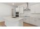 Modern kitchen island with white cabinets, quartz countertops, and stainless steel appliances at 7010 E Drygulch Rd, San Tan Valley, AZ 85143