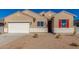 Tan two-story house with white garage door and red shutters at 7010 E Drygulch Rd, San Tan Valley, AZ 85143