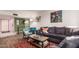 Living room with L-shaped sofa, hardwood floors, and large window at 3017 W Hearn Rd, Phoenix, AZ 85053