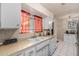Kitchen features white cabinets, double sink, and tile flooring at 3017 W Hearn Rd, Phoenix, AZ 85053