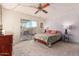 Bedroom with queen bed, ceiling fan, and access to backyard at 3017 W Hearn Rd, Phoenix, AZ 85053