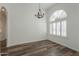 Bright dining room features wood floors, an arched window, and a chandelier at 1223 E Clearview Dr, Casa Grande, AZ 85122