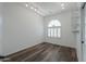 Well-lit bedroom with wood floors and arched window at 1223 E Clearview Dr, Casa Grande, AZ 85122