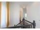 Upstairs hallway with black railing and access to bedrooms and bathrooms at 1223 E Clearview Dr, Casa Grande, AZ 85122
