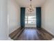 Formal dining room with hardwood floors, large windows, and teal curtains at 1223 E Clearview Dr, Casa Grande, AZ 85122