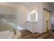Clean bathroom features a vanity with a lighted mirror and a barn door at 1223 E Clearview Dr, Casa Grande, AZ 85122