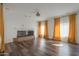 Bright living room featuring hardwood floors, a fireplace, and large windows at 1223 E Clearview Dr, Casa Grande, AZ 85122