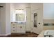 Bright bathroom boasts a vanity with modern cabinets and a large mirror at 1223 E Clearview Dr, Casa Grande, AZ 85122