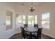 Charming breakfast nook with a round table and four chairs, overlooking the pool at 1223 E Clearview Dr, Casa Grande, AZ 85122