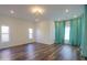 Spacious bedroom with hardwood floors and teal curtains at 1223 E Clearview Dr, Casa Grande, AZ 85122